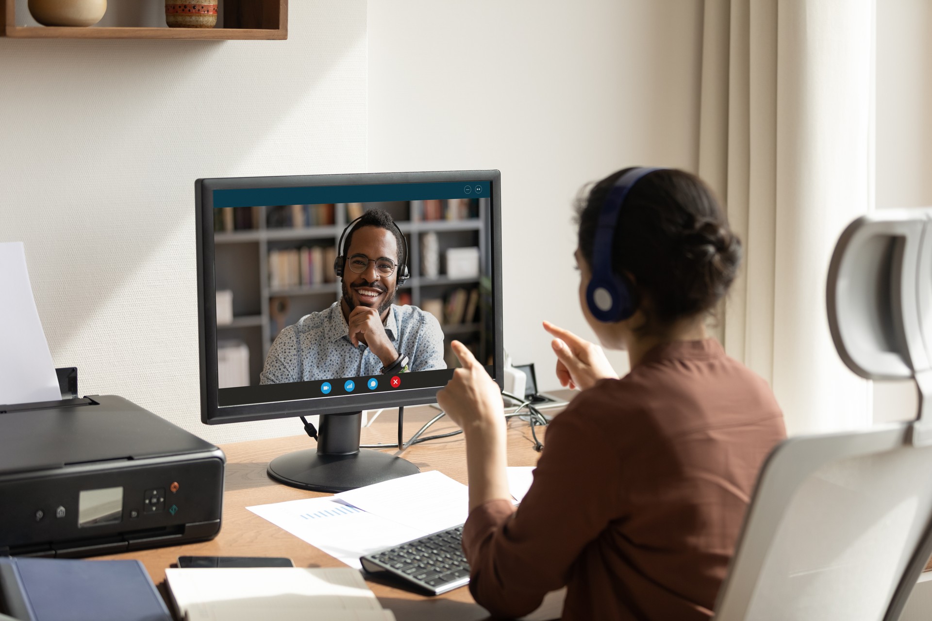 Woman talk to African colleague using pc and videocall app